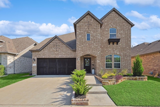 french country inspired facade featuring a garage and a front yard