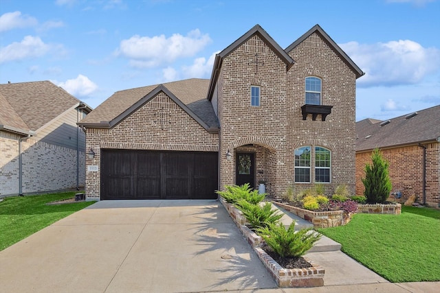 view of front of property with a garage and a front yard