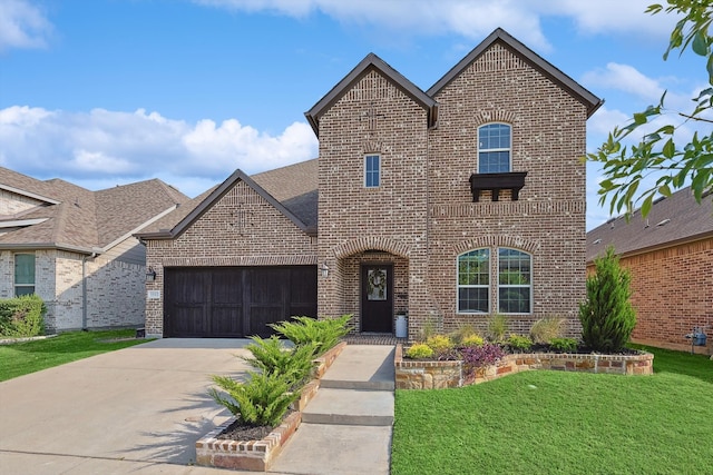 view of front of home with a garage and a front lawn