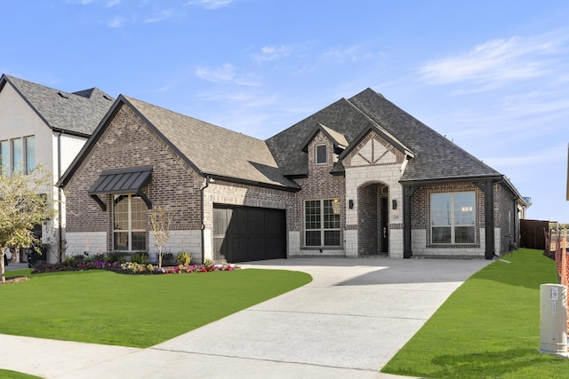 view of front of property with a front yard and a garage