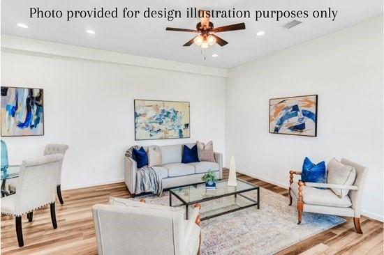 living room with ceiling fan and hardwood / wood-style floors