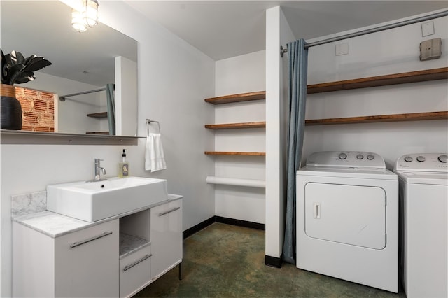 clothes washing area with sink and independent washer and dryer