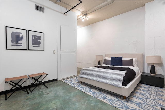 bedroom featuring concrete floors