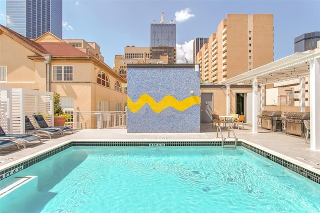 view of swimming pool featuring a pergola, a patio area, and a grill