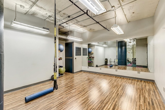 workout area with hardwood / wood-style floors