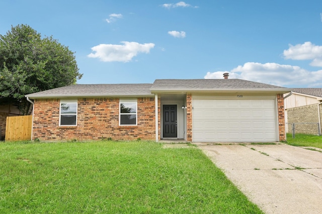 ranch-style house featuring a garage and a front lawn