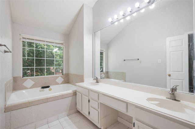 bathroom featuring dual vanity, tiled bath, tile patterned floors, and vaulted ceiling