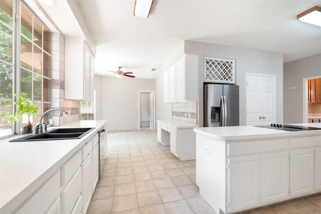 kitchen featuring white cabinetry, backsplash, ceiling fan, appliances with stainless steel finishes, and a healthy amount of sunlight