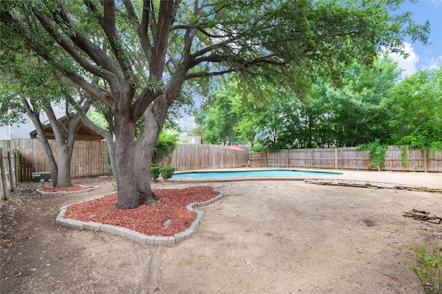 view of yard with a fenced in pool