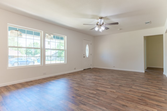 interior space with dark wood-type flooring and ceiling fan