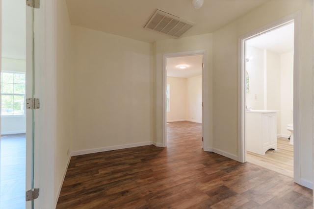 unfurnished room with dark wood-type flooring