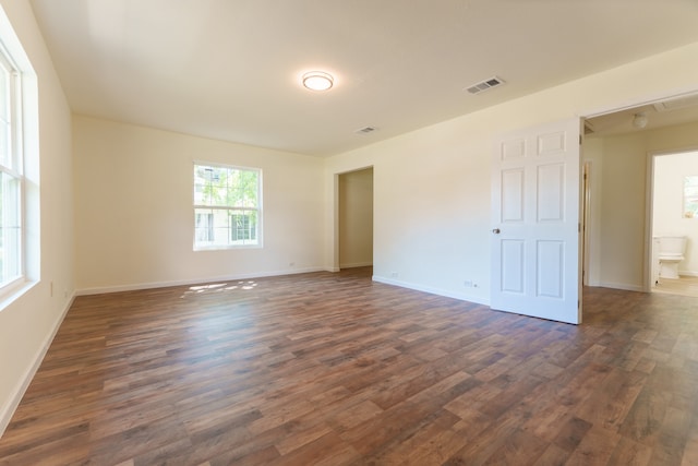 spare room featuring dark wood-type flooring