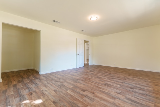 unfurnished room with wood-type flooring