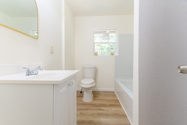 bathroom featuring vanity, hardwood / wood-style flooring, and toilet