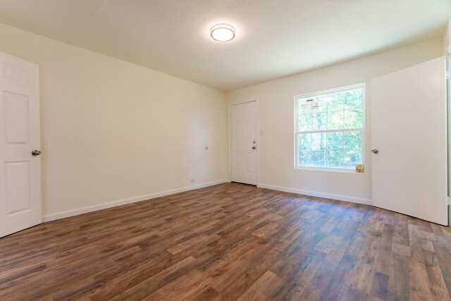 empty room featuring dark hardwood / wood-style flooring