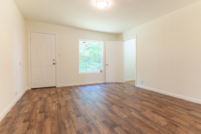 empty room with dark wood-type flooring