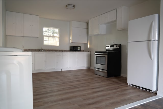 kitchen with washer / dryer, stainless steel electric range oven, wood-type flooring, white fridge, and white cabinets