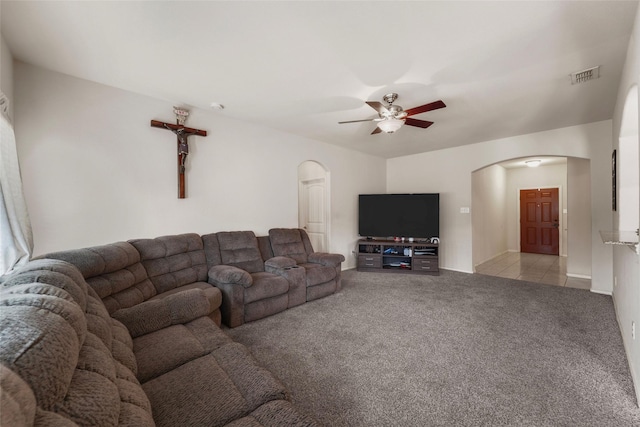 carpeted living room with ceiling fan