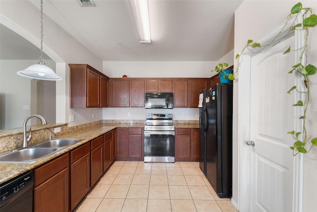 kitchen featuring light stone countertops, decorative light fixtures, light tile patterned floors, black appliances, and sink