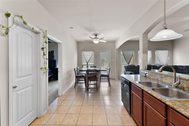 kitchen featuring decorative light fixtures, light tile patterned floors, ceiling fan, black dishwasher, and sink