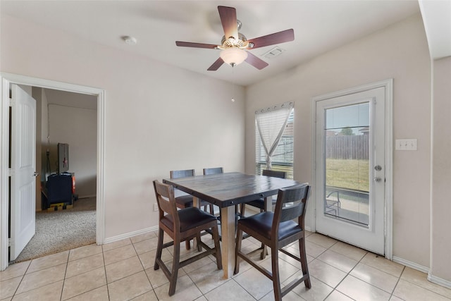 tiled dining area with ceiling fan