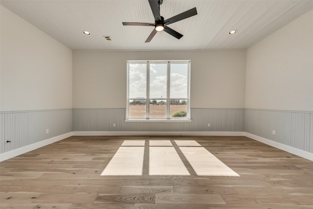 empty room with light hardwood / wood-style flooring and ceiling fan