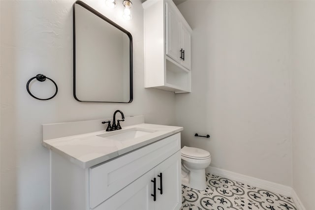 bathroom with vanity, toilet, and tile patterned floors