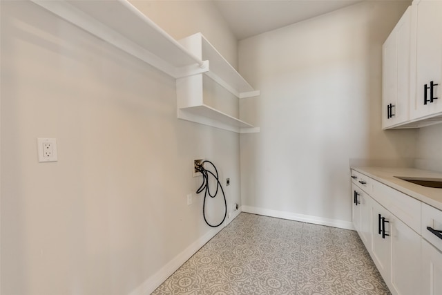 laundry area with cabinets, hookup for a washing machine, and light tile patterned floors