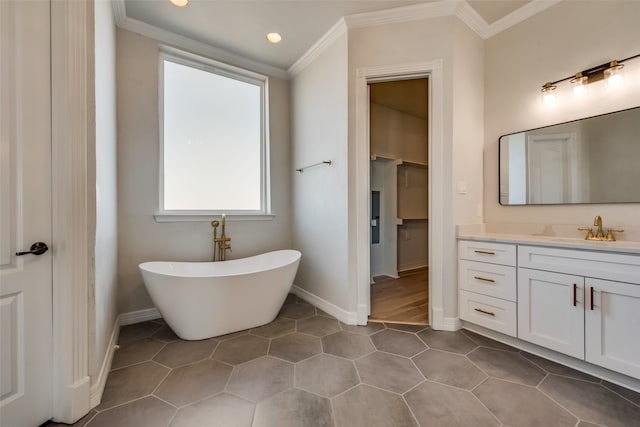 bathroom featuring ornamental molding, vanity, tile patterned floors, and a tub to relax in