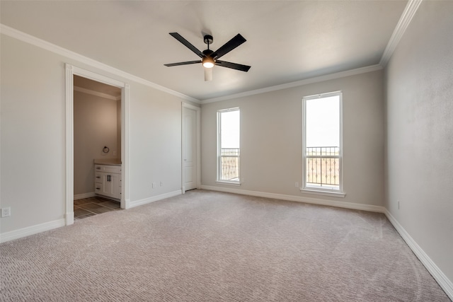 unfurnished bedroom with crown molding, connected bathroom, carpet, and ceiling fan