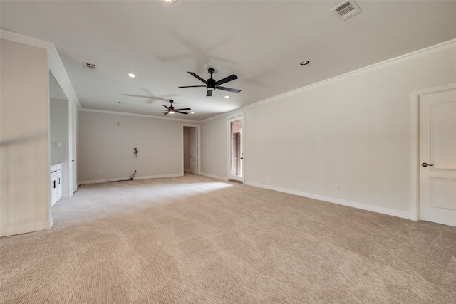 carpeted spare room featuring ornamental molding and ceiling fan