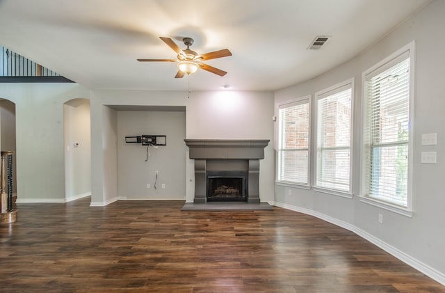 unfurnished living room featuring dark hardwood / wood-style floors and ceiling fan