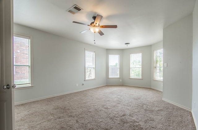 carpeted empty room featuring ceiling fan