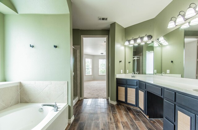 bathroom with vanity and independent shower and bath