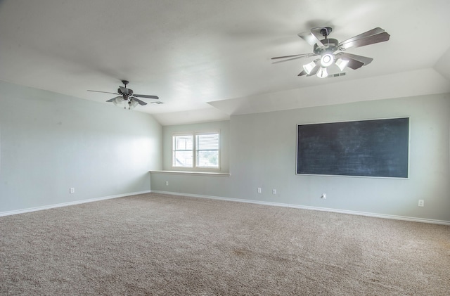 carpeted spare room featuring ceiling fan and lofted ceiling