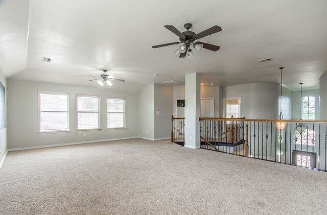 carpeted empty room with ceiling fan and lofted ceiling