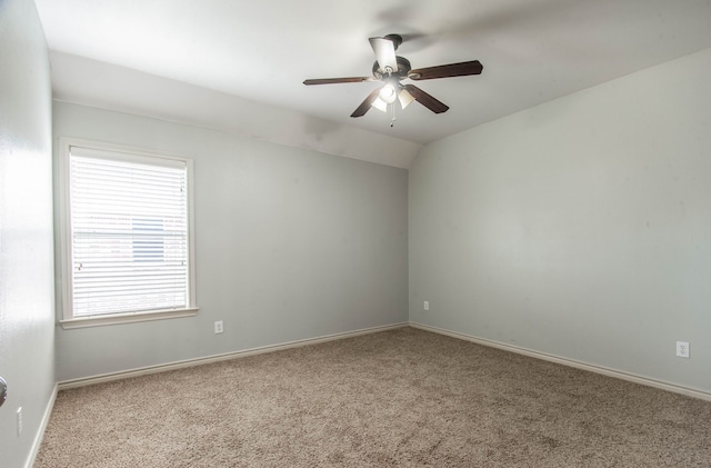 empty room featuring light colored carpet, ceiling fan, and lofted ceiling