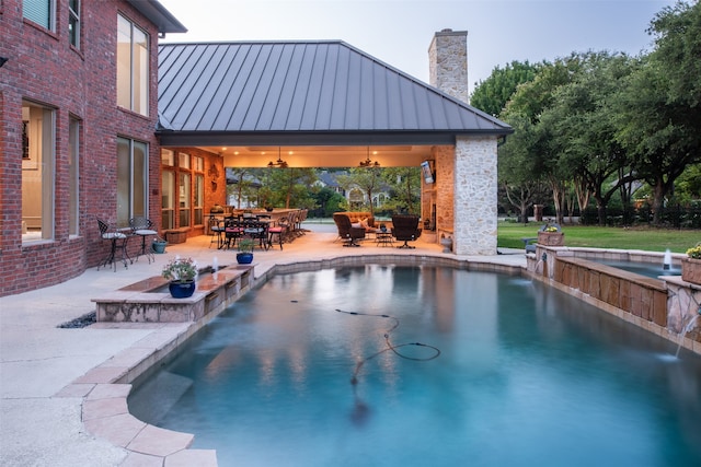 pool featuring outdoor dining space, a patio area, and ceiling fan