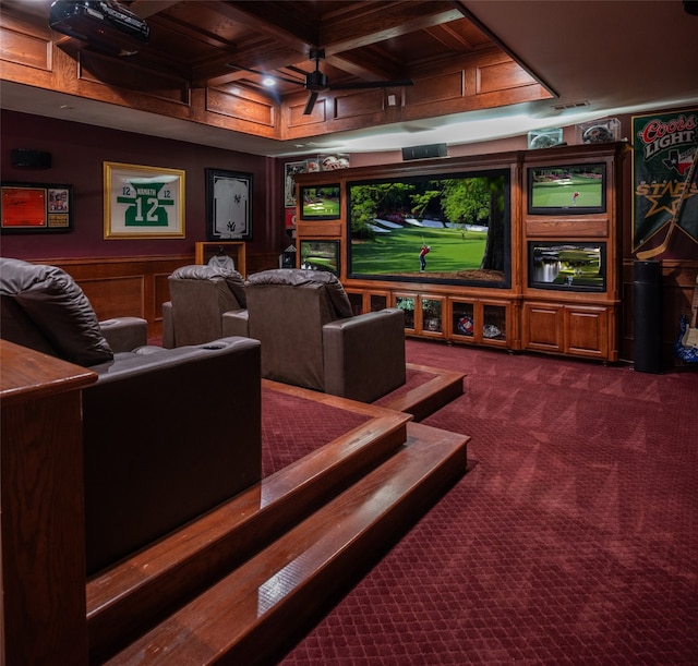 carpeted cinema room with beam ceiling, ceiling fan, and coffered ceiling