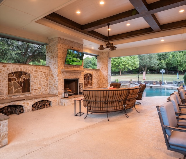 view of patio featuring an outdoor stone fireplace