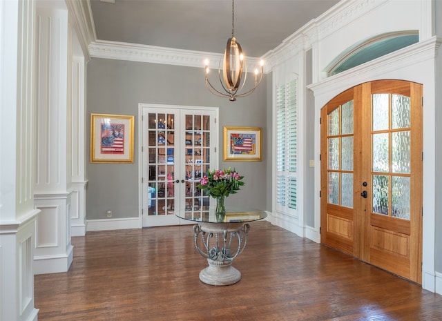 foyer entrance with dark hardwood / wood-style flooring, crown molding, french doors, and plenty of natural light