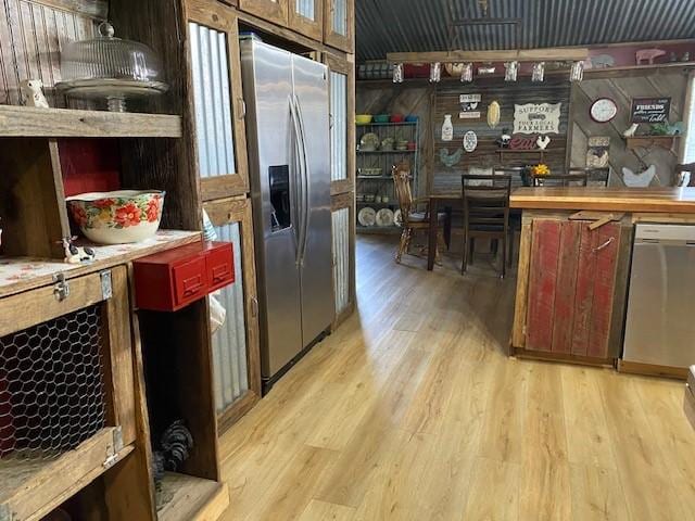 kitchen featuring stainless steel appliances and light hardwood / wood-style floors