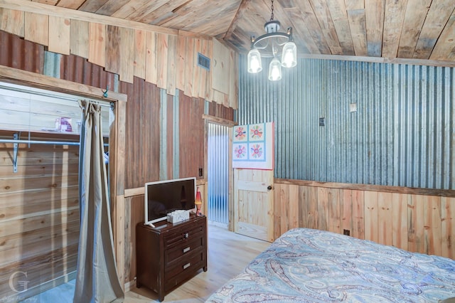 bedroom featuring light hardwood / wood-style floors, wooden ceiling, and wood walls