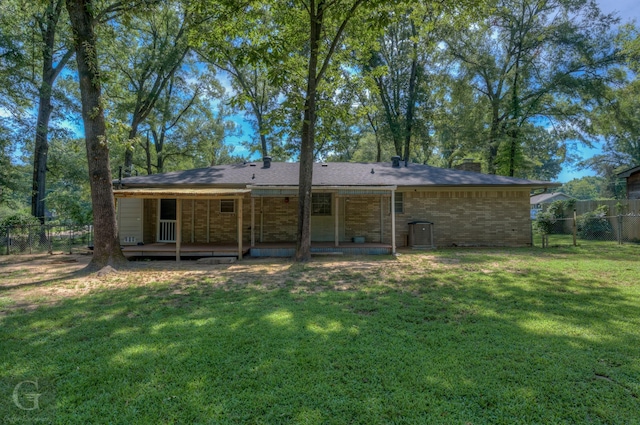 rear view of house with a lawn