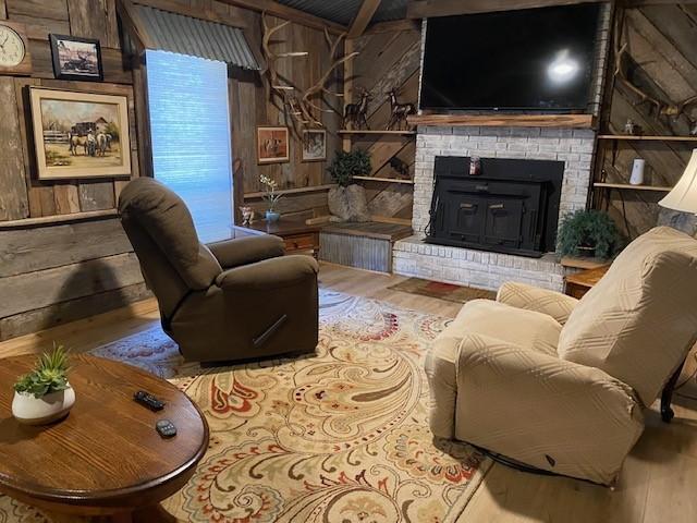 living room featuring wooden walls and wood-type flooring