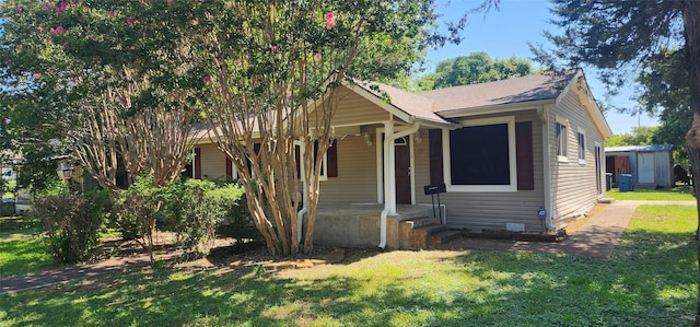 bungalow-style home with a front yard