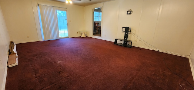 unfurnished living room featuring dark colored carpet