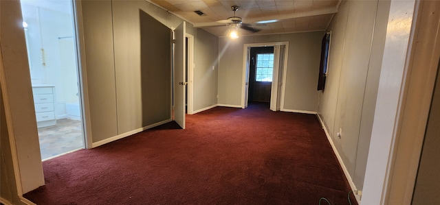 additional living space featuring dark carpet and ceiling fan