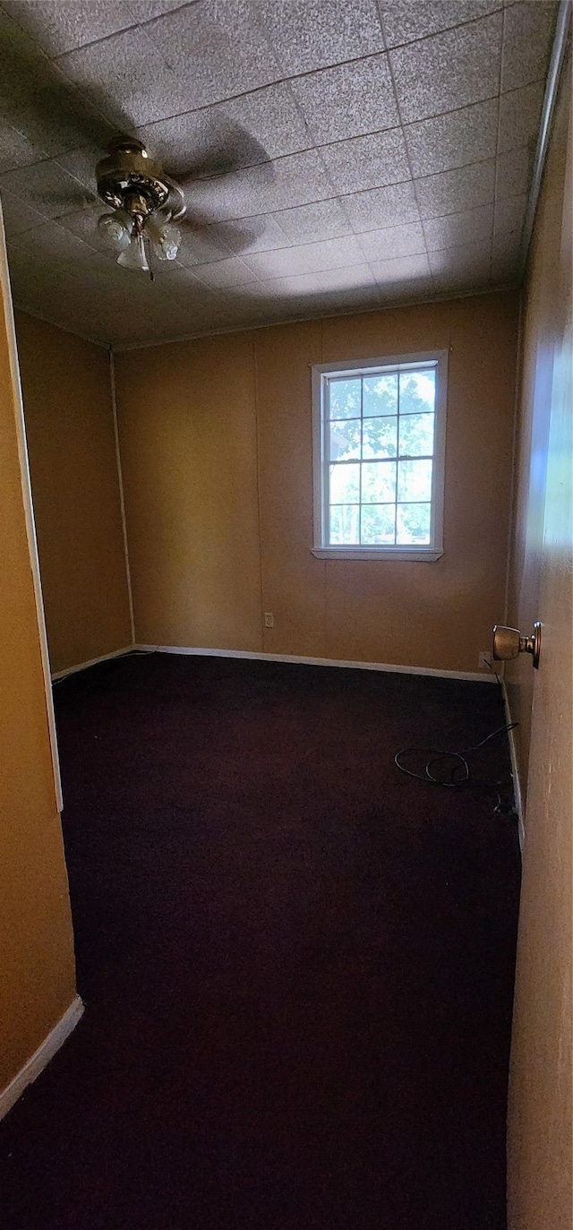 spare room featuring ceiling fan and a paneled ceiling