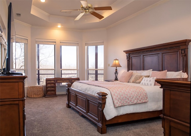 carpeted bedroom featuring crown molding, ceiling fan, and a raised ceiling